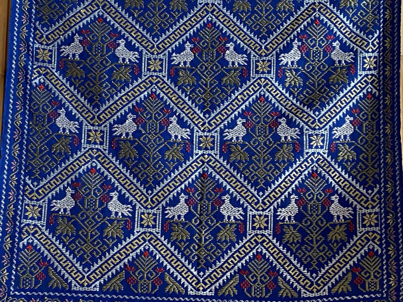 Copriletto blu con il punto del giudice appeso a una parete in legno
